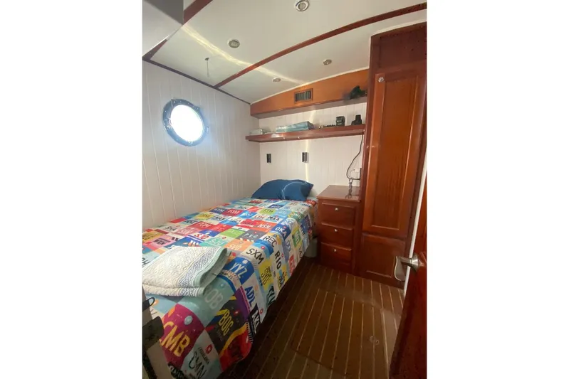 Korkzcrew Yacht Photos Pics Cozy cabin interior of 2008 Great Harbour N37 with colorful bedding and wooden furnishings.