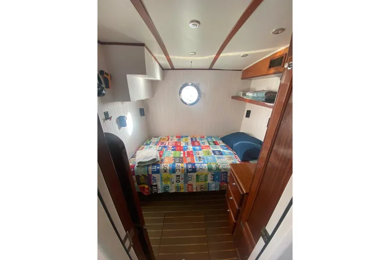 Korkzcrew Yacht Photos Pics Cozy cabin interior of 2008 Great Harbour N37 with colorful bedding and wooden accents.