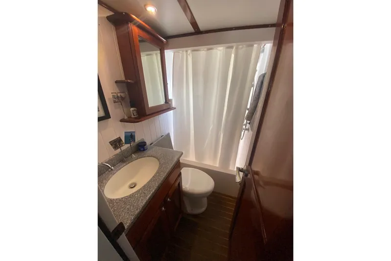 Korkzcrew Yacht Photos Pics Bathroom interior of 2008 Great Harbour N37 yacht with sink, toilet, and shower curtain.