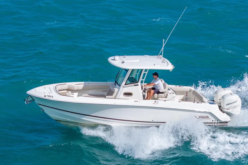  Yacht Photos Pics 2016 Boston Whaler 280 Outrage cruising on blue ocean waters.