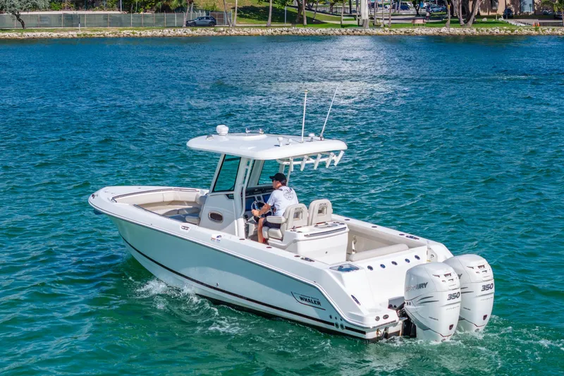  Yacht Photos Pics 2016 Boston Whaler 280 Outrage boat cruising on clear blue water.