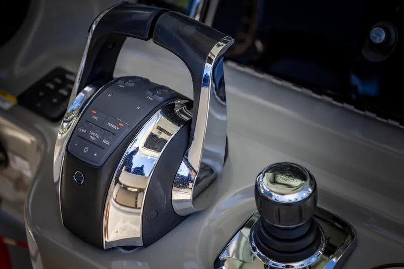  Yacht Photos Pics Control panel of a 2016 Boston Whaler 280 Outrage boat, featuring throttle and joystick.