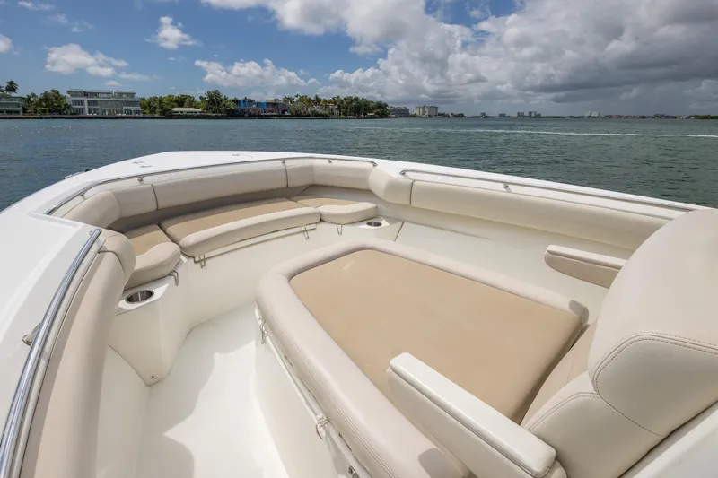  Yacht Photos Pics 2016 Boston Whaler 280 Outrage boat interior with beige seating, on a sunny day.