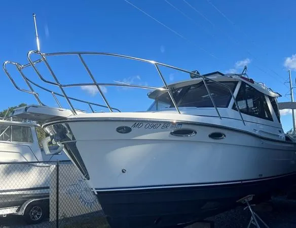  Yacht Photos Pics 2016 Cutwater C-28 boat with sleek design, docked under clear blue sky.