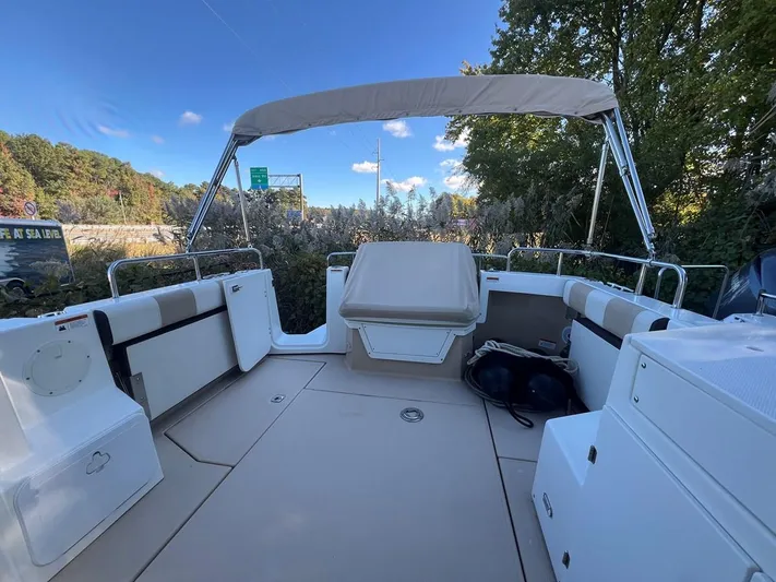  Yacht Photos Pics 2016 Cutwater C-28 boat deck with seating, canopy, and scenic background.