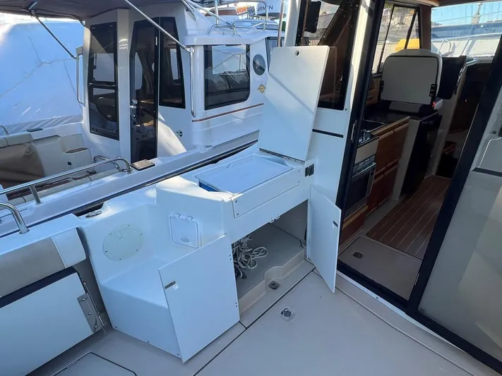  Yacht Photos Pics 2016 Cutwater C-28 boat interior with open storage compartments and seating area.