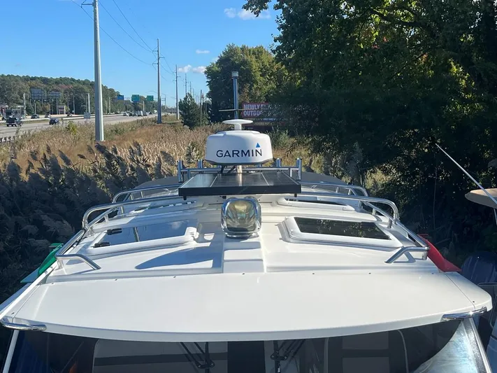  Yacht Photos Pics 2016 Cutwater C-28 boat with Garmin radar, docked near a highway.