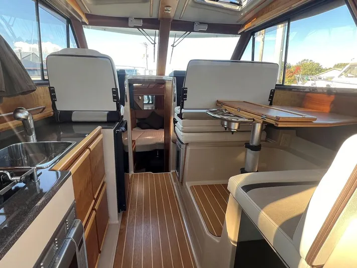  Yacht Photos Pics Interior of 2016 Cutwater C-28 boat with modern kitchen and seating area.