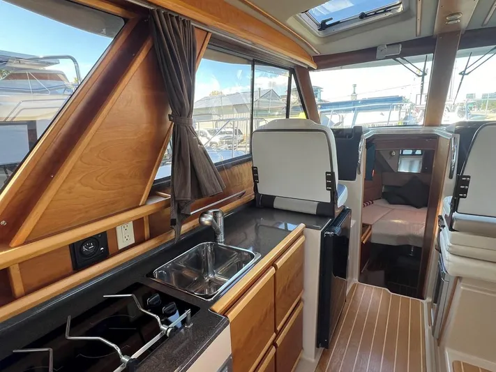  Yacht Photos Pics Interior of 2016 Cutwater C-28 boat with kitchen and seating area.