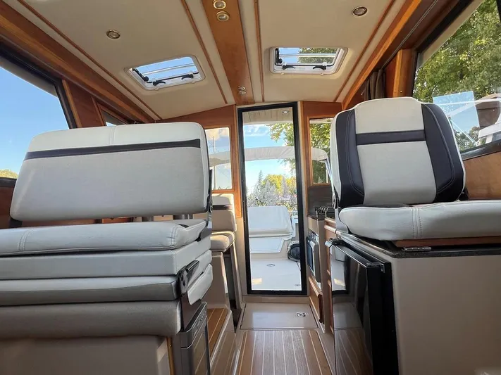  Yacht Photos Pics Interior of 2016 Cutwater C-28 boat with modern seating and wood accents.