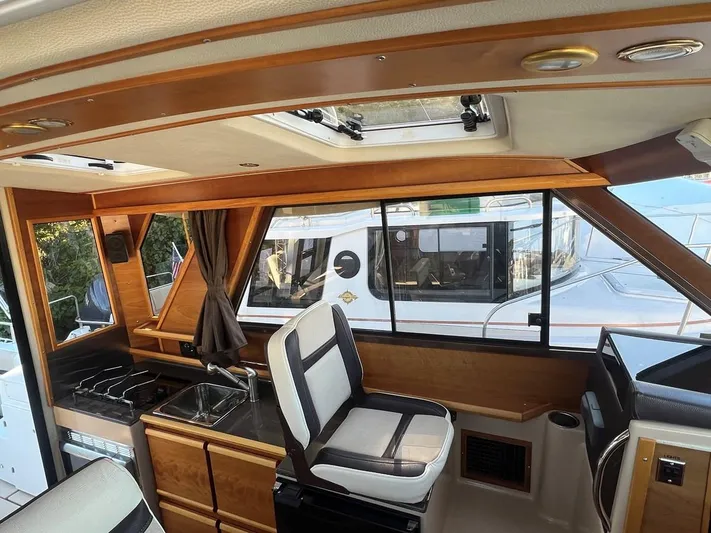  Yacht Photos Pics Interior of 2016 Cutwater C-28 boat with wood finish and seating.