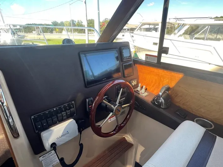  Yacht Photos Pics 2016 Cutwater C-28 helm with Garmin navigation, steering wheel, and control panel.