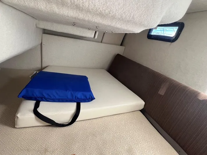  Yacht Photos Pics Interior cabin of 2016 Cutwater C-28 boat with cushion and blue bag.