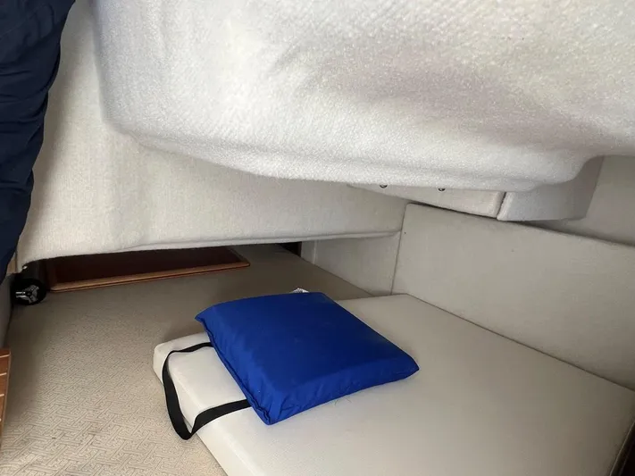  Yacht Photos Pics Interior cabin of 2016 Cutwater C-28 boat with blue cushion on beige seating.