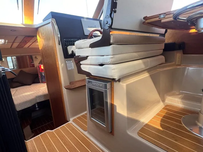 Yacht Photos Pics Interior of 2016 Cutwater C-28 boat with seating and wood accents.