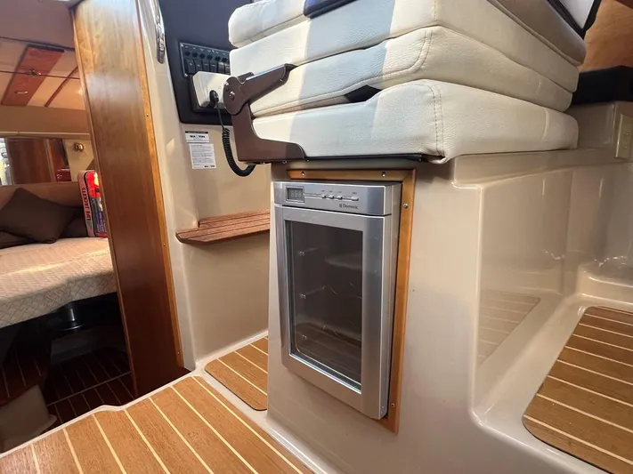  Yacht Photos Pics 2016 Cutwater C-28 interior with compact fridge and cozy cabin seating.