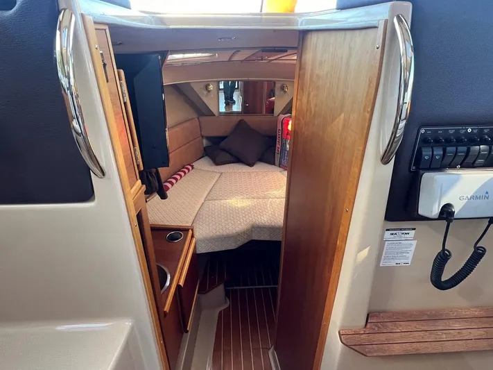  Yacht Photos Pics Interior cabin of 2016 Cutwater C-28 boat with cozy bed and wooden accents.