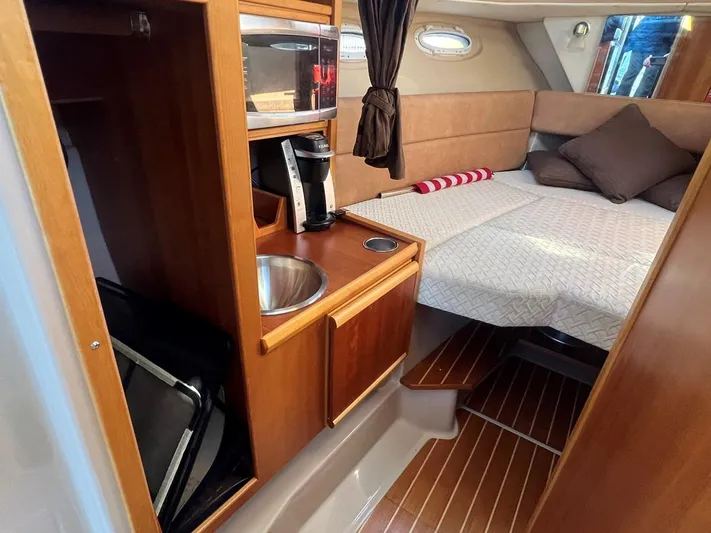  Yacht Photos Pics 2016 Cutwater C-28 cabin interior with kitchenette and cozy sleeping area.