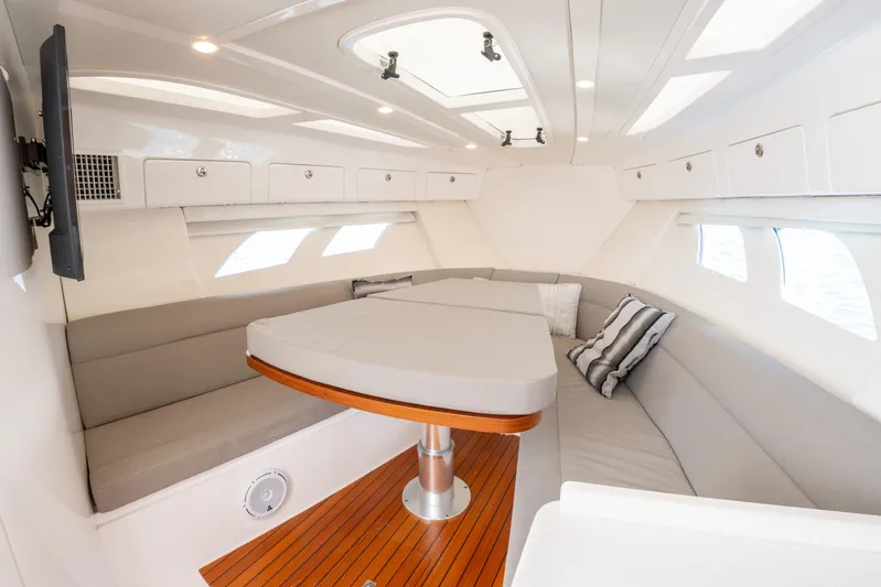  Yacht Photos Pics Luxurious interior of 2019 Intrepid 407 Cuddy boat with elegant seating and table.