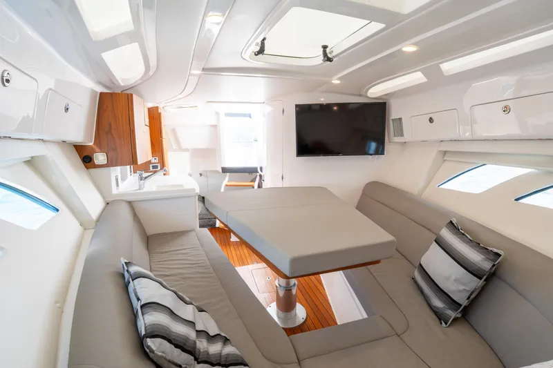 Yacht Photos Pics Luxurious interior of 2019 Intrepid 407 Cuddy boat with modern seating and entertainment system.