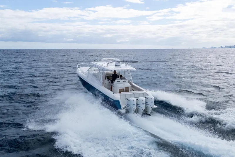  Yacht Photos Pics 2019 Intrepid 407 Cuddy cruising on open ocean with triple outboard engines.