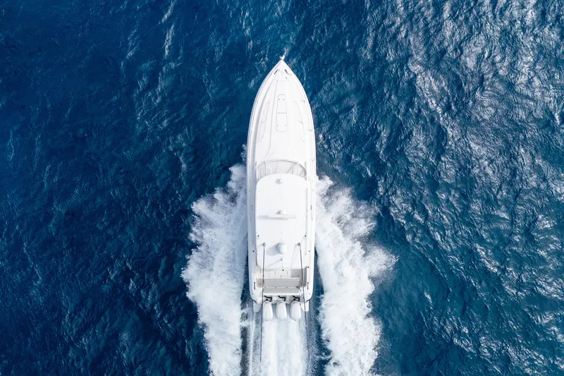  Yacht Photos Pics Aerial view of 2019 Intrepid 407 Cuddy boat cruising on open blue ocean.