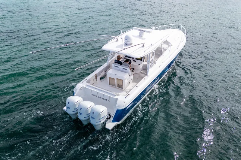  Yacht Photos Pics 2019 Intrepid 407 Cuddy cruising on open water, featuring triple outboard engines.