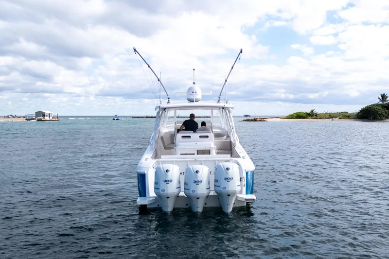  Yacht Photos Pics 2019 Intrepid 407 Cuddy boat on water, featuring triple outboard engines.
