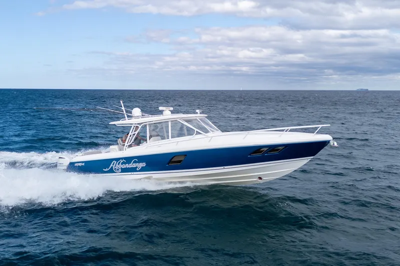  Yacht Photos Pics 2019 Intrepid 407 Cuddy cruising on open sea under cloudy sky.