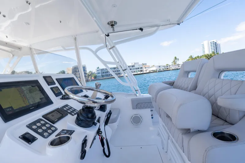  Yacht Photos Pics 2019 Intrepid 407 Cuddy helm with modern controls and luxurious seating on open water.