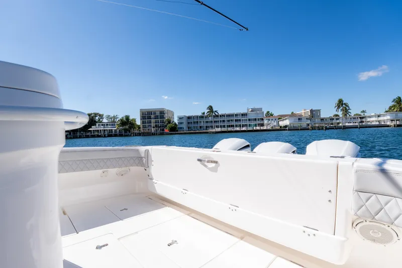  Yacht Photos Pics 2019 Intrepid 407 Cuddy boat with waterfront view and clear blue sky.