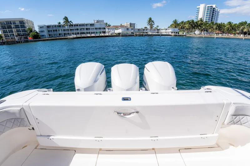  Yacht Photos Pics 2019 Intrepid 407 Cuddy boat with triple engines on a sunny waterfront.