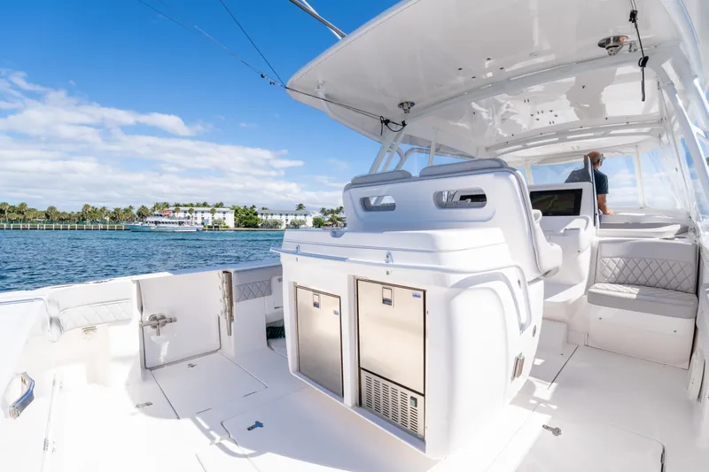  Yacht Photos Pics 2019 Intrepid 407 Cuddy boat interior with seating and ocean view.
