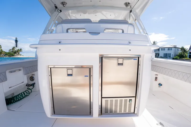  Yacht Photos Pics 2019 Intrepid 407 Cuddy boat interior with stainless steel storage, ocean view.
