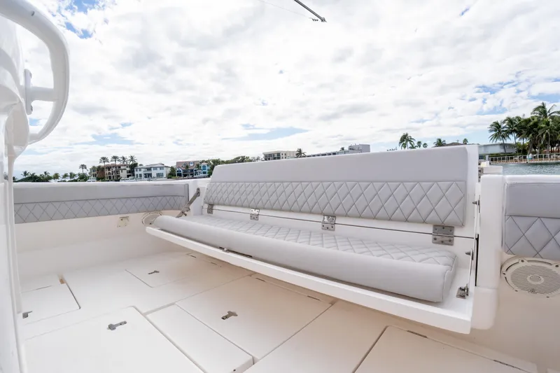  Yacht Photos Pics 2019 Intrepid 407 Cuddy boat with luxurious seating and scenic waterfront view.