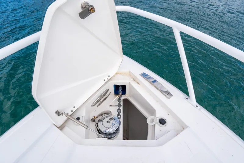  Yacht Photos Pics 2019 Intrepid 407 Cuddy anchor locker with open hatch, showing marine equipment.