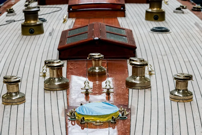 Wings K-15 Yacht Photos Pics Deck of a 1937 Classic 12-metre yacht with polished brass fittings.