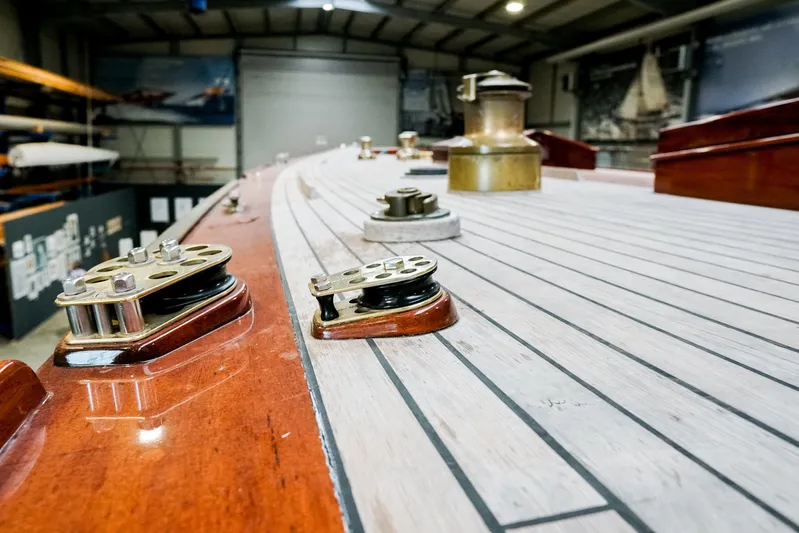 Wings K-15 Yacht Photos Pics Deck of a 1937 Classic 12-metre yacht with polished wood and metal fittings.