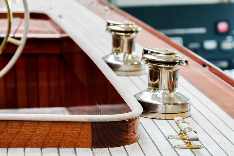 Wings K-15 Yacht Photos Pics Polished winches on a 1937 Classic 12-metre yacht deck, showcasing elegant craftsmanship.