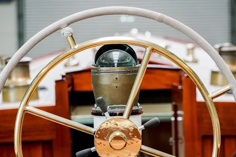 Wings K-15 Yacht Photos Pics Steering wheel and compass of a 1937 Classic 12-metre yacht.