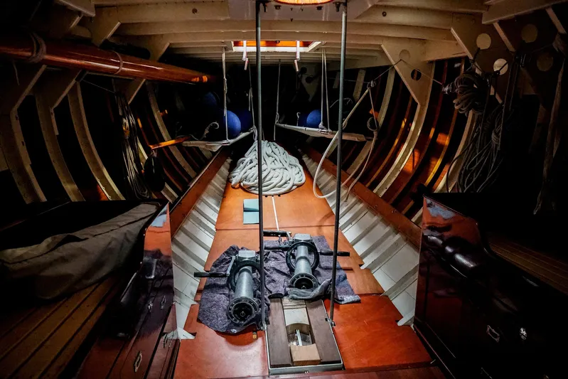 Wings K-15 Yacht Photos Pics Interior of a 1937 Classic 12-metre yacht, showcasing wooden craftsmanship and nautical equipment.