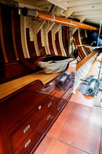 Wings K-15 Yacht Photos Pics Interior of a 1937 Classic 12-metre yacht with polished wood and storage compartments.