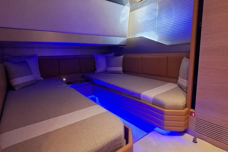 M/y Catch Me Yacht Photos Pics Luxurious interior of 2010 Otam 58 yacht with ambient blue lighting and cozy seating.