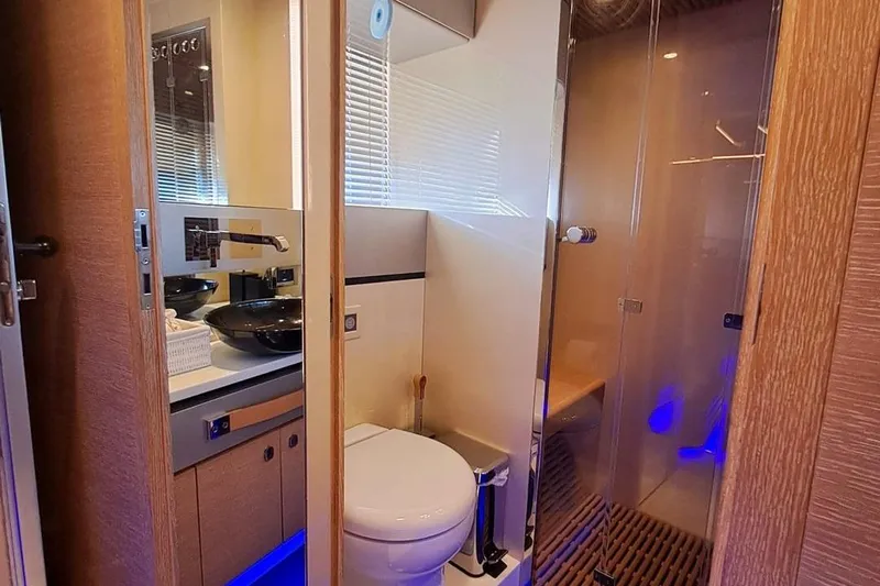 M/y Catch Me Yacht Photos Pics Luxurious bathroom interior of 2010 Otam 58 yacht with modern fixtures and ambient lighting.