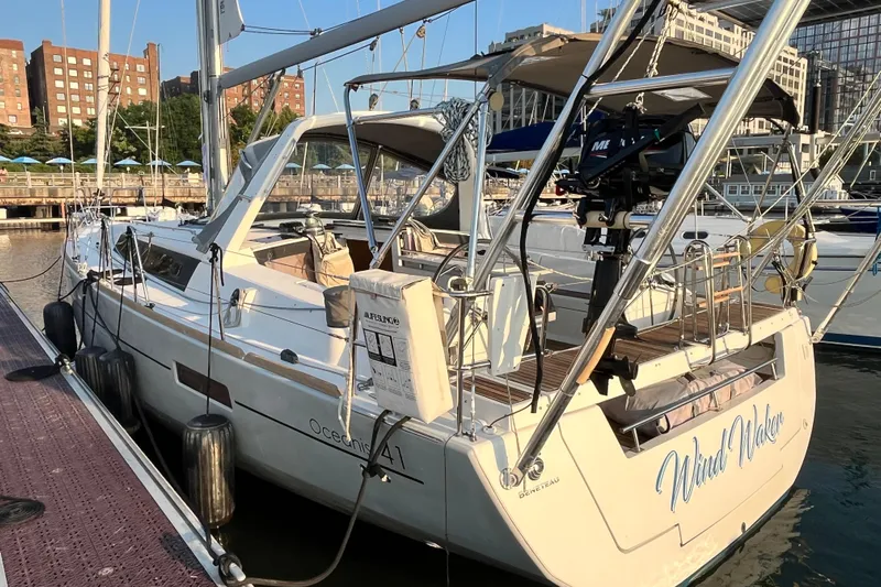 Wind Walker Yacht Photos Pics 2013 Beneteau Oceanis 41 sailboat docked at marina, sunny day, urban backdrop.