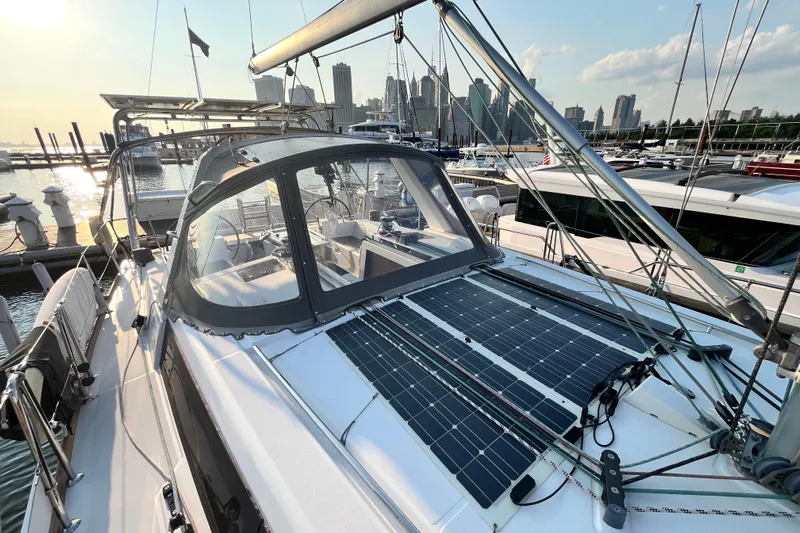 Wind Walker Yacht Photos Pics 2013 Beneteau Oceanis 41 sailboat with solar panels docked in a marina at sunset.