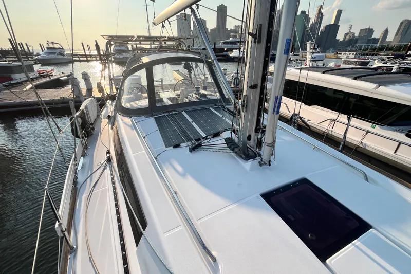 Wind Walker Yacht Photos Pics 2013 Beneteau Oceanis 41 sailboat docked at marina, city skyline in background.