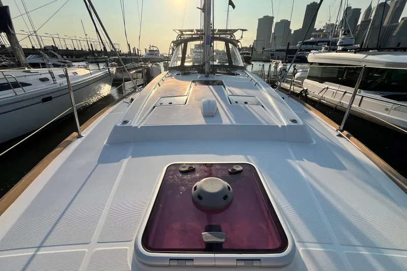 Wind Walker Yacht Photos Pics 2013 Beneteau Oceanis 41 sailboat deck at sunset in marina, city skyline background.