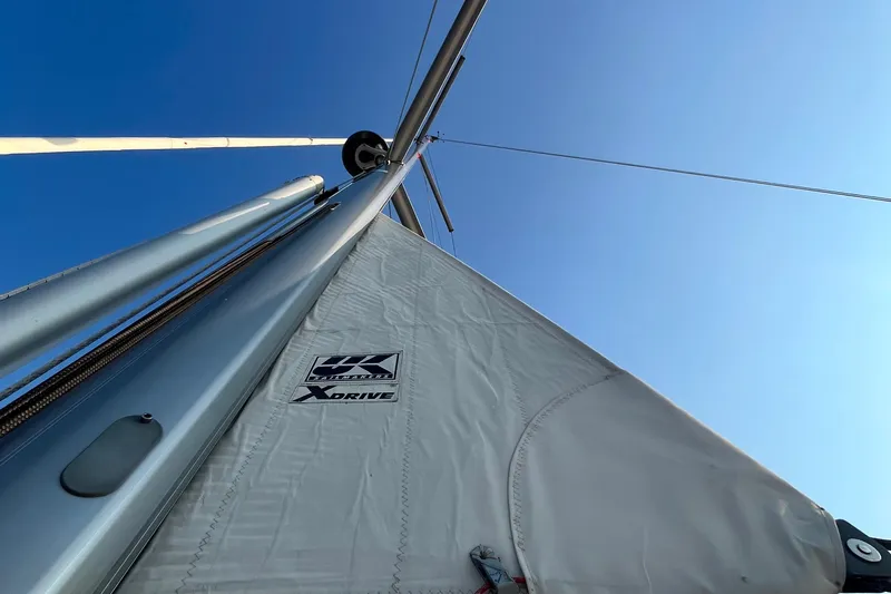 Wind Walker Yacht Photos Pics Close-up of Beneteau Oceanis 41 sailboat mast and sail against clear blue sky.
