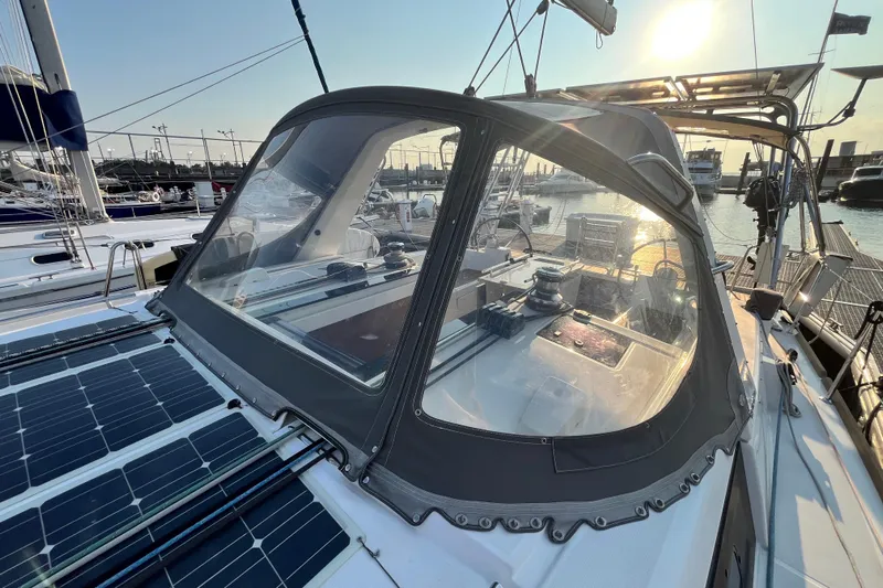 Wind Walker Yacht Photos Pics 2013 Beneteau Oceanis 41 sailboat with cockpit enclosure, docked at marina during sunset.